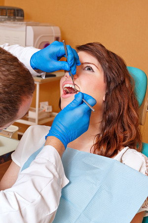 Young girl on examination at the dentist in the dental clinicの写真素材