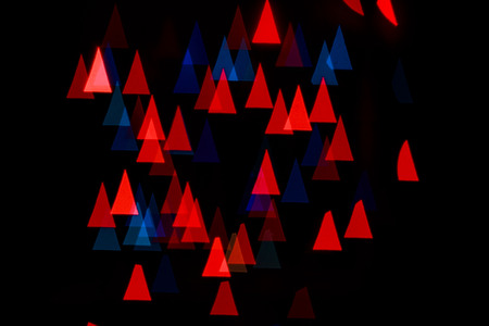 Multicolored abstract background of lights in the shape of triangles not in focusの写真素材