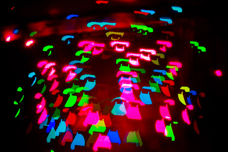 Multicolored abstract background of lights in the form of the phone is not in focus