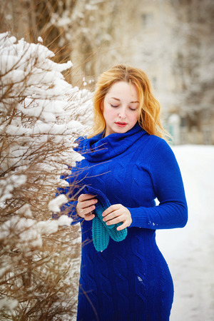 Portrait of a young cute girl in winter park on a sunny dayの写真素材