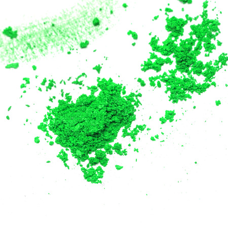 Green scattered cosmetics eye shadow. The concept of fashion and beauty industry.の写真素材