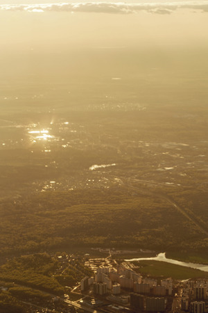 City landscape from the window the plane at an altitude of clouds crossing the line. Aerial view. Concept travel.の写真素材