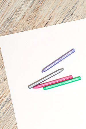 Pastels of blue, gray, red and green colors on a blank sheet of paper. Space for text. The concept of drawing and design.の写真素材