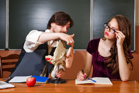 Male student teacher explains the structure of the human earの写真素材