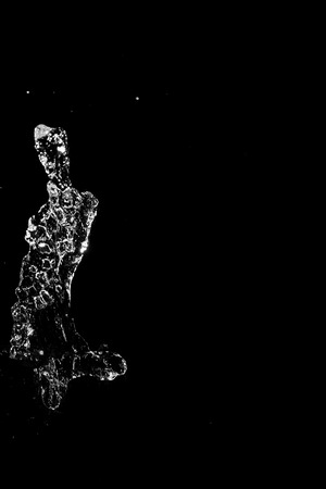 Abstract jet of water on a black background. Texture. Design elements. Spray. Refreshing.の写真素材