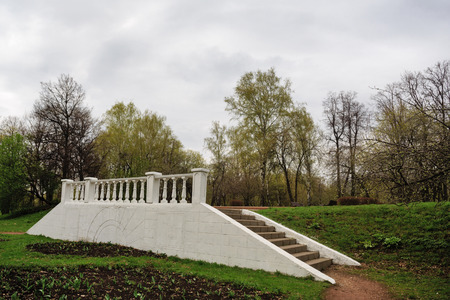Veranda in the city park. Trees. Nature background. Green lawn in the park. Early morning. Without people. The concept of love for nature.の写真素材