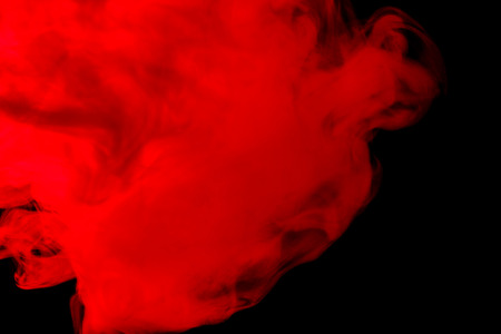 Abstract red-orange hookah smoke on a black background. Photographed using a gel filter. Texture....
