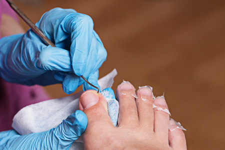 Master chiropody cleans fingernails. Spa. Concept body care.の写真素材