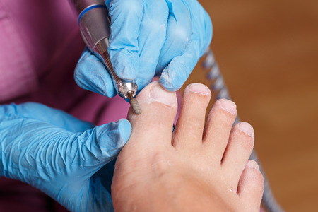 Master chiropody shapes the nails and cuticles close up. Hardware manicure. Concept body care.の写真素材