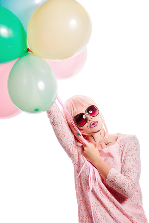 Girl with makeup in the style of pop art. Girl holding balloons. The concept of holiday and fun.の写真素材