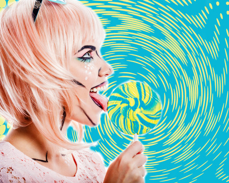 Girl with makeup in the style of pop art holding lollipop and licking it. Colorful background. The concept of the sweet life. Retro fashion. Vintage postcard. Sweets.の写真素材