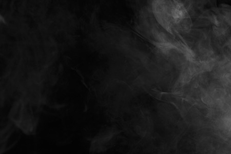 Abstract art. Grey smoke hookah on a black background. Inhalation. Steam Generator. The concept of aromatherapy.の写真素材
