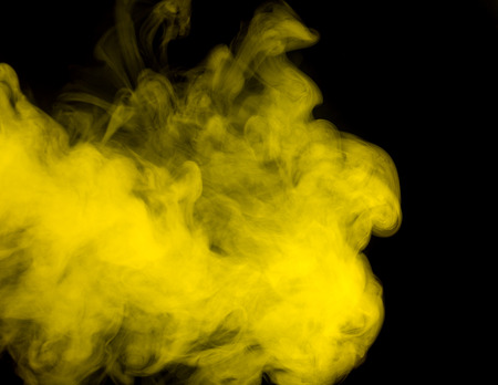 Abstract art. Yellow smoke hookah on a black background. Inhalation. The steam generator. The concept of poison gas.の写真素材