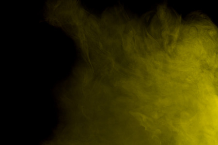 Abstract art. Yellow smoke hookah on a black background. Inhalation. The steam generator. The concept of poison gas.の写真素材