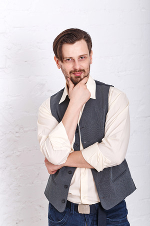 Young romantic man in the vest. Men's fashion. Man thinking about eternity.の写真素材