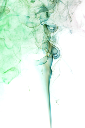 Abstract art. Colored smoke from the incense sticks on a white background. Background for Halloween. Texture fog. Design element. The concept of aromatherapy.の写真素材