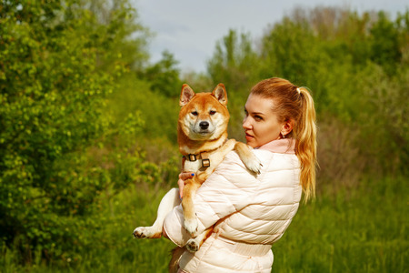 Girl holds a dog.の写真素材