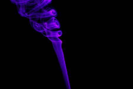 Abstract art. Color blue smoke from the aromatic sticks on a black background.の写真素材
