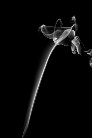 Abstract art. Gray smoke from the incense on a black background. Background for Halloween. Texture fog. Design element. The concept of aromatherapy.の写真素材