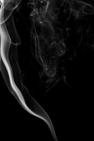 Abstract art. Gray smoke from the incense on a black background. Background for Halloween. Texture fog. Design element. The concept of aromatherapy.の写真素材