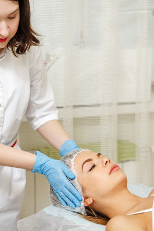 Prepare the girl's face to the microcurrent therapy. Hardware cosmetology. Cosmetic procedures. Spa.の写真素材