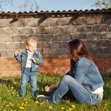 Mother and daughter in the backyard. Girls happy. Spring mood. Family time.