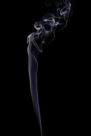 Abstract art. Color white blue smoke from the aromatic sticks on a black background. Background for Halloween. Texture fog. Design element. The concept of aromatherapy.の写真素材
