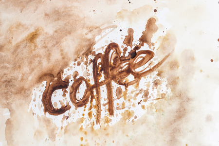 The inscription of coffee on paper tinted with black coffee. The inscription is made by the ice cream of the coffee mash. Favourite drink.の写真素材