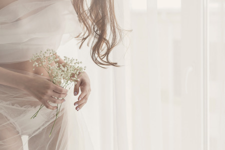 Lovely girl in lingerie. Sensual photo. Man is unrecognizableの写真素材