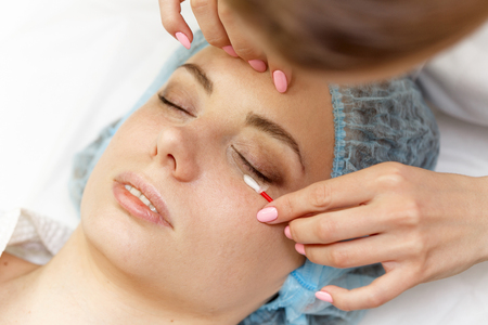 Beauty salon. Straightening eyelashes before the procedure of building. Shooting close-up.の写真素材
