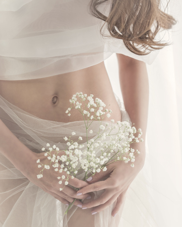 Cute girl in white lingerie. Sensual photo. Man is unrecognizableの写真素材