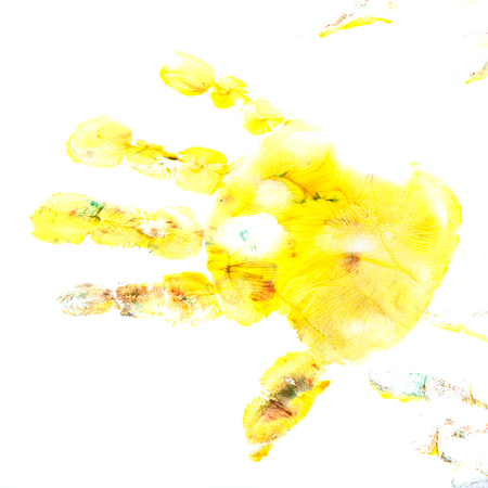 Yellow imprint of a child's hand gouache. Finger paint. Children's creativity.の写真素材
