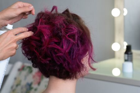 Textured Curls Hairdo. Hairdresser makes hairstyle to client. Hairdressing services. Ð¡reating hairstyle. Beauty salon. Space for text.の写真素材