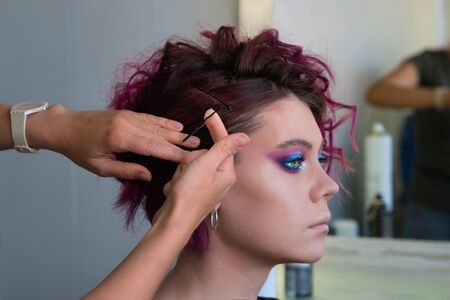 Textured Curls Hairdo. Hairdresser makes hairstyle to client. Hairdressing services. Creating...