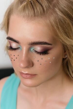 Portrait of attractive woman with eyes closed. Cute charming girl with big curls. Fashion, beauty, evening make-up, hairstyle, beautiful, spectacular, glitter.の写真素材