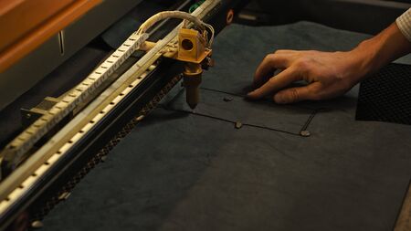 Laser cutting beam artificial leather High precision. Modern machine industrial technology of...