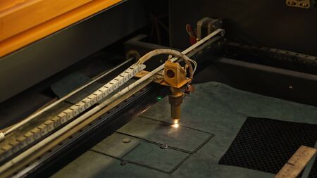 Laser cutting beam artificial leather High precision. Modern machine industrial technology of artificial leather cutting. CNC laser. Masterclass, workshop sessionの写真素材
