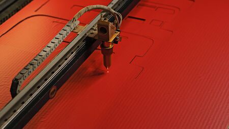 Laser cutting beam high precision on a paperboard. Modern machine industrial technology of...