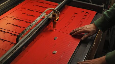 Laser cutting beam high precision on a paperboard. Modern machine industrial technology of...