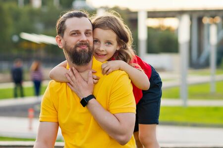 Family portrait. Daughter hugs father. Family fun. Beautiful family together. Leisure together....