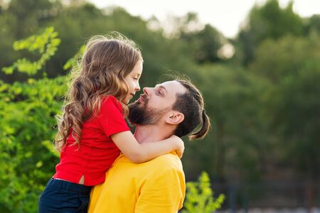 Family portrait. Daughter hugs father. Family fun. Beautiful family together. Leisure together. Smiling daughter. Family holiday concept. Happy childhood. Father day concept.の写真素材