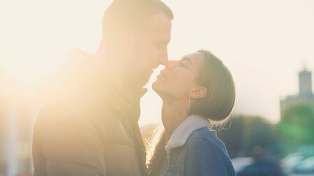 Couple for lifestyle design. Young couple on romantic date sunny day. Leisure together. Young people. Sunset. Sweet kissの写真素材