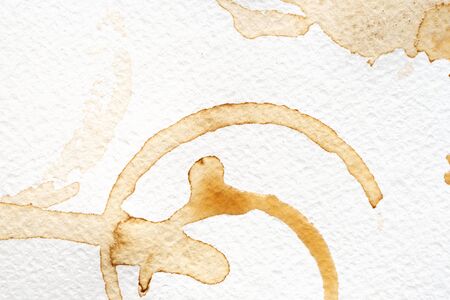 Abstract liquid drops splash brown coffee on a white texture paper background for watercolor. Artistic decoration or backdrop. Banner for text, grunge element.の写真素材