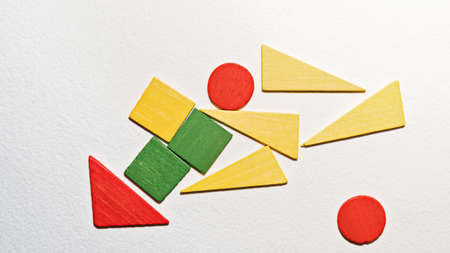 Different colorful shapes wooden on white background. Geometric shapes red, green, yellow colors,...