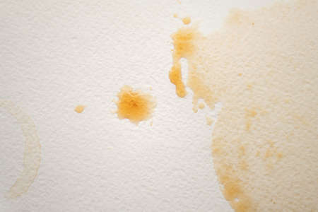 Abstract liquid drops splash brown coffee on a white texture paper background for watercolor....