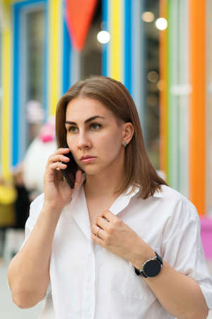 Focused Serious Busy Businesswoman Talking On Phone. Lady In White Shirt Using Mobile Phone