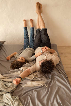 Dad and daughter at home. Happy family. Father puts his daughter to bed. Chatting before bed. Spend time togetherの写真素材