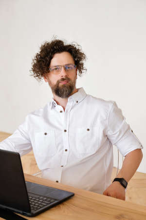 Businessman Working On Laptop In Kitchen Area Of Modern Flat. Network. Working From Home During...