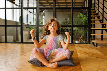 Child Girl Playing Meditates in Yoga Pose. Yoga Exercise At Home. Breathing Exercise. Relaxing...