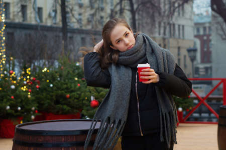 Happy teen girl with coffee at christmas market in evening. winter holidays, hot drinks and people...